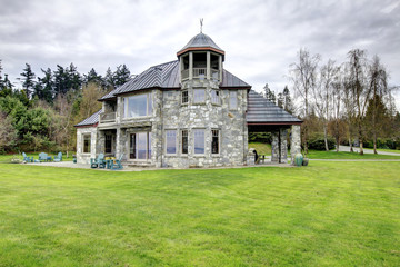 Fototapeta na wymiar Amazing stone house with a big column porch