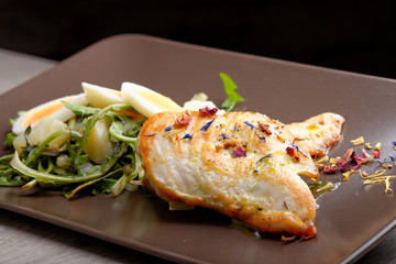 Grilled chicken fillet and dandelions with egg