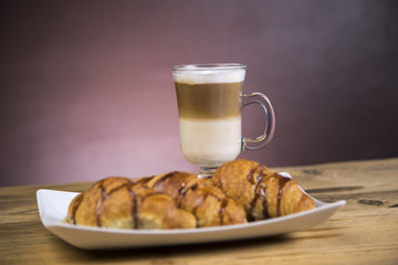 Coffee with whipped cream and croissant, donuts