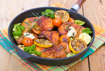 Roasted chicken legs in the pan