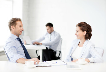 man and woman discussing something in office