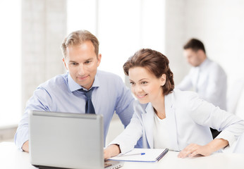 Fototapeta premium man and woman working with laptop in office