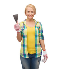 smiling female worker in gloves with spatula