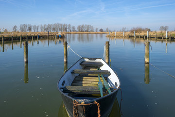 Naklejka premium Rowing boat docked in a small harbor
