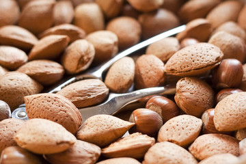 Mixed nuts in a bowl with metal nutcrackers