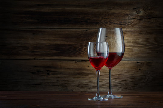 glasses of wine on a wooden background
