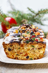 Fruitcake with dried fruits and nuts in christmas setting