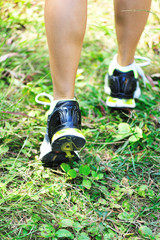 runner fit running on green grass