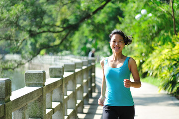fitness woman running at trail in park
