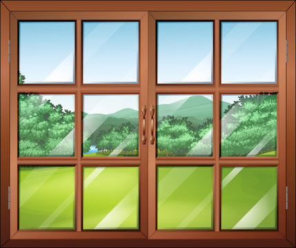 A closed window with a view of the green surroundings