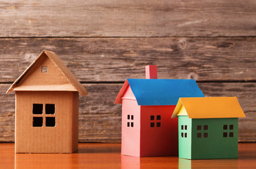 houses from the paper on wooden background