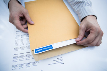 man hand with pen and business report