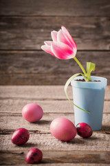 tulips and easter eggs on wooden background