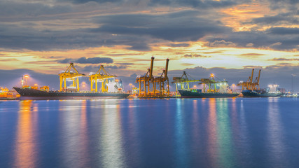 Fototapeta premium Container Cargo freight ship with working crane bridge in shipya