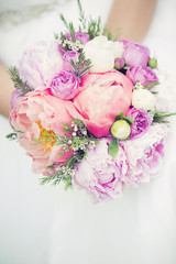 Beautiful wedding bouquet in hands of the bride