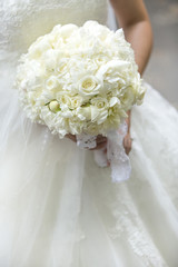Beautiful wedding bouquet in hands of the bride