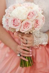 Beautiful wedding bouquet in hands of the bride