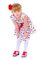 Cheerful little girl with red rose, braided hair, joking in the