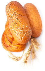 Baked breads with spikelets of wheat isolated on white