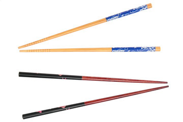 Two pairs of wood chopsticks on white