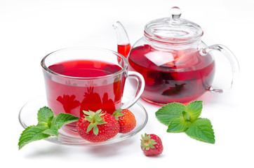 kettle and a cup of red tea with strawberries and mint isolated