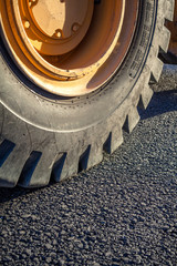 Close-up excavator tire in the road