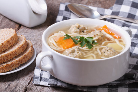 Soup with noodles and meatballs on the table