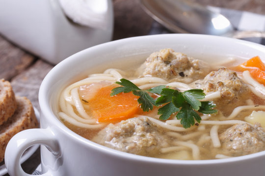 Soup with noodles and meatballs closeup