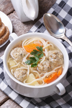 Soup with meatballs, noodles, potatoes vertical