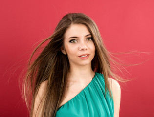 Fototapeta premium Portrait of beautiful woman on red background