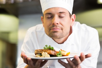 Fototapeta na wymiar Closeup of a chef with eyes closed smelling food