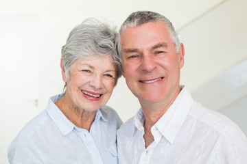 Happy retired couple smiling at camera