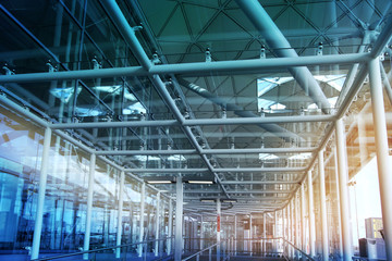 Glass tunnel with sun light British airport interior