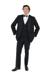 Handsome groom standing over white background