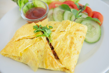 stuffed omelette with salad and ketchup