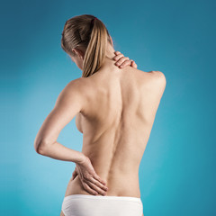 Close-up of woman with naked back over blue background