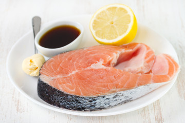 raw salmon with sauce and lemon