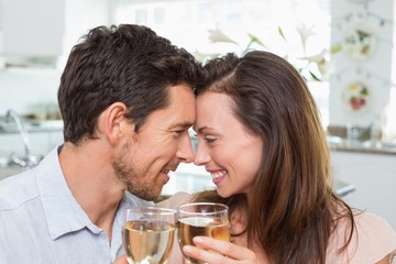 Loving couple with wine glasses at home