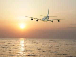 Fototapeta na wymiar corporate jet airplane flying at sunset