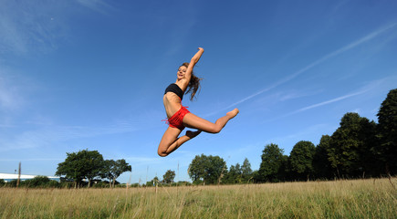 Fototapeta na wymiar Woman jumping in the air