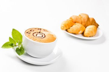 large cup of coffee and croissants on a plate