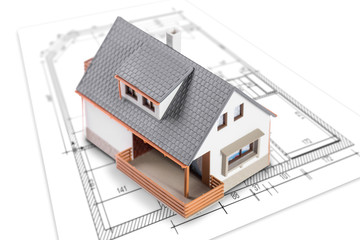 House standing on plan or blueprints