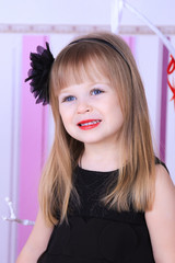 Little girl in black dress with makeup
