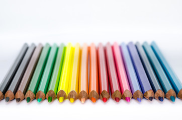 Colorful pencils in a row on white background