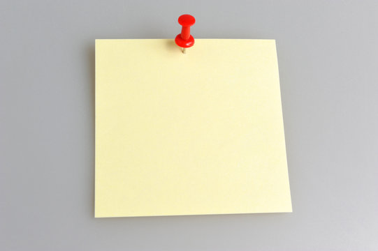 Yellow Paper Sheet Attached With Office Button On Gray Backgroun