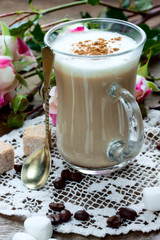 coffee latte with cinnamon on lace serviette
