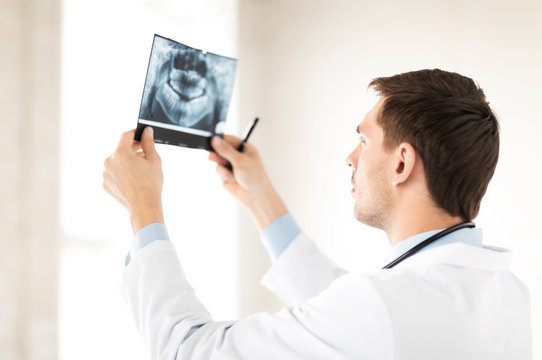 male doctor or dentist looking at x-ray