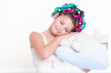 Cute little girl in curlers and pajamas sleep bedtime