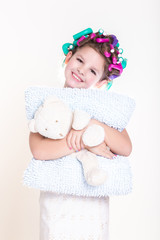Cute little girl in curlers and pajamas sleep bedtime