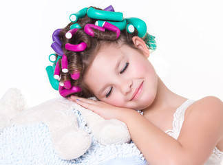 Obraz na płótnie Canvas funny little girl in curlers and pajamas sleep bedtime